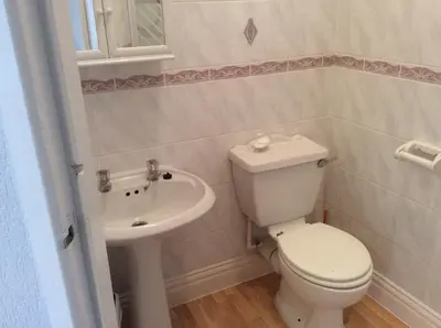 a bathroom with a toilet and a sink at Beaucliffe continental in Blackpool