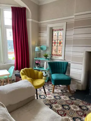 a living room with a couch and two chairs at Beaucliffe continental in Blackpool