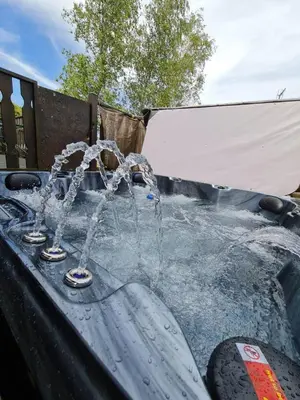 a pool of water with two fountains at 4 Bed Luxury Lodge with Hot tub near Lake District in Warton