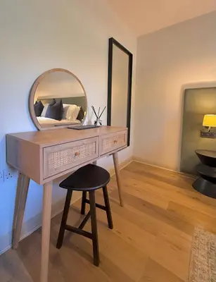 a dressing table with a mirror and a stool at Little Wren Cartmel Couples Retreat in Cartmel