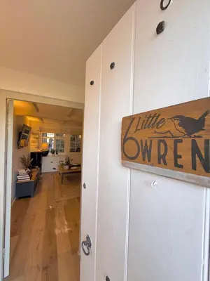 a white door with a sign that reads little overheard at Little Wren Cartmel Couples Retreat in Cartmel