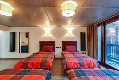 two beds sitting next to each other in a room at Alberts Apartments in Liverpool