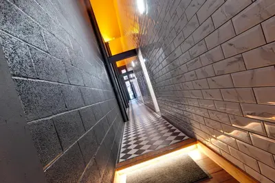 a hallway of a building with a brick wall at Alberts Apartments in Liverpool