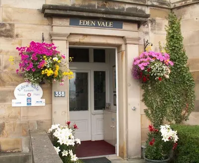 a entrance to a building with flowers in front of it at Eden Vale First Floor Sea View Apartment in Morecambe