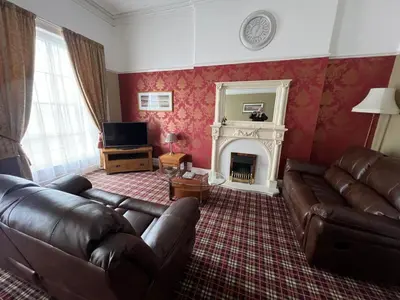 a living room with a couch and a fireplace at Eden Vale First Floor Sea View Apartment in Morecambe