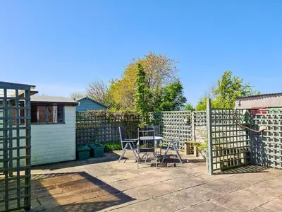 a patio with a fence and a table and chairs at Marrion House in Middleton