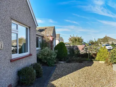 a garden outside a house with a window at Marrion House in Middleton