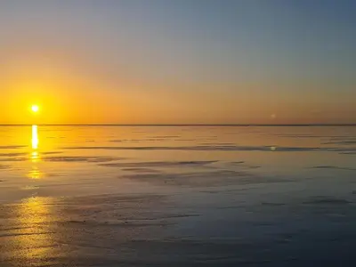 a sunset over the ocean with the sun setting at Marrion House in Middleton