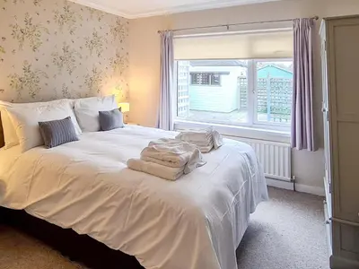 a bedroom with a white bed with towels on it at Marrion House in Middleton