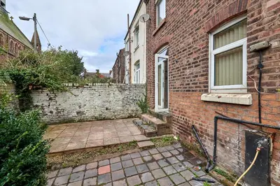 a brick building with a patio in front of it at Contractors and Pets Welcome, Only 2 miles from M57, M58, Whole House Rental Sleeps 4 to 9, Short Walk to Orrell Station in Liverpool