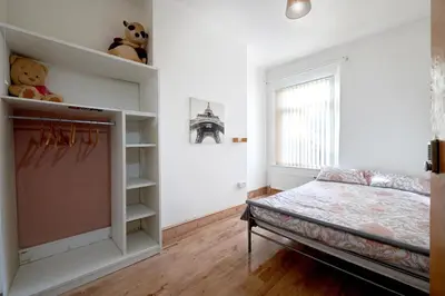 a bedroom with a bed and a book shelf at Contractors and Pets Welcome, Only 2 miles from M57, M58, Whole House Rental Sleeps 4 to 9, Short Walk to Orrell Station in Liverpool