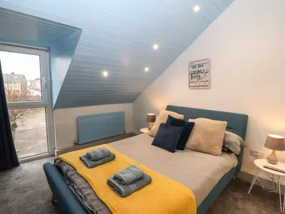 a bedroom with a bed with two towels on it at Harbour View in Millom