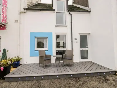 a patio with chairs and a table on a building at Harbour View in Millom
