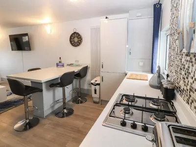 a kitchen with a stove and a counter top at Harbour View in Millom