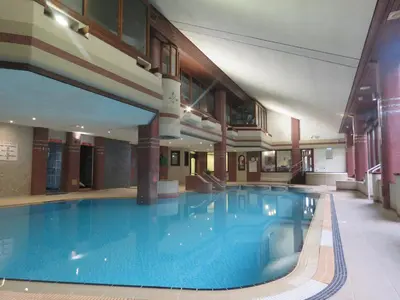 a large swimming pool in a large building at Harbour View in Millom