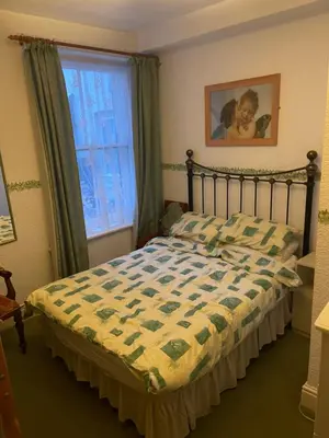 a bedroom with a bed and a window at Highbury Hotel in Blackpool