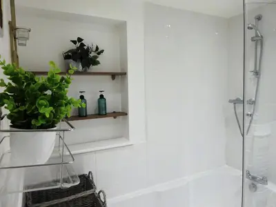 a bathroom with a shower and a potted plant at InstaLet Apartments I Wigan Central I Free Parking in Wigan