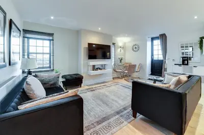 a living room with two couches and a tv at InstaLet Apartments I Wigan Central I Free Parking in Wigan