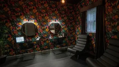 a room with a wall covered in floral wallpaper at Hotel 105 in Liverpool