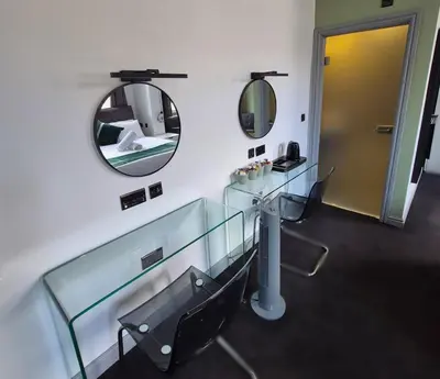 a bathroom with a mirror and a glass sink at Hotel 105 in Liverpool