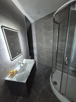 a bathroom with a sink and a shower at Hotel 105 in Liverpool