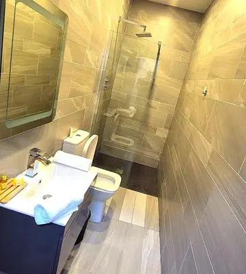 a bathroom with a toilet and a sink and a shower at Hotel 105 in Liverpool