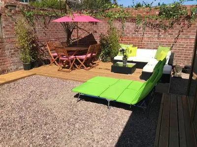a patio with a table and chairs and an umbrella at The Beach House South - Blackpool - Entire Holiday Home in Blackpool