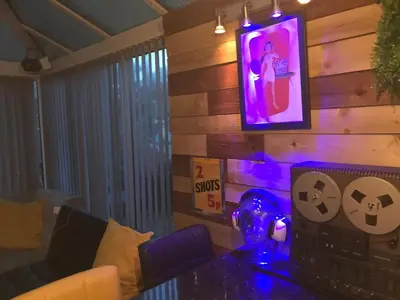 a living room with a couch and a tv on a wall at The Beach House South - Blackpool - Entire Holiday Home in Blackpool