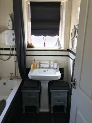 a small bathroom with a sink and a window at The Beach House South - Blackpool - Entire Holiday Home in Blackpool