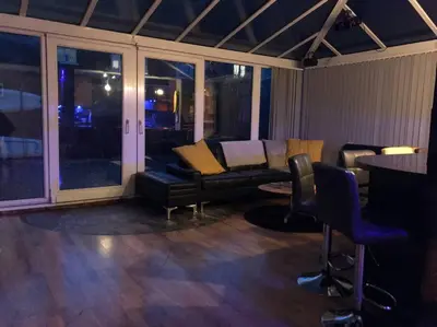 a living room with a couch and chairs and a table at The Beach House South - Blackpool - Entire Holiday Home in Blackpool