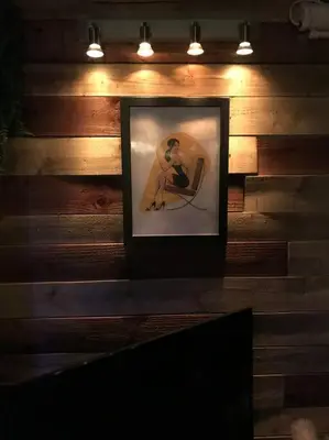 a picture of a woman sitting in a chair on a wall at The Beach House South - Blackpool - Entire Holiday Home in Blackpool