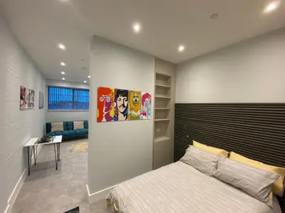 a bedroom with a bed with a large headboard at Kempston Suites Liverpool Apartment 4 in Liverpool