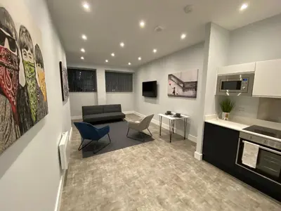 a living room with a couch and a table and chairs at Kempston Suites Liverpool Apartment 4 in Liverpool