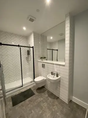 a bathroom with a toilet and a shower and a sink at Kempston Suites Liverpool Apartment 5 in Liverpool