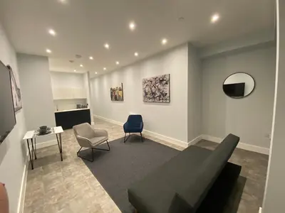 a living room with a couch and a chair at Kempston Suites Liverpool Apartment 6 in Liverpool