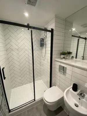a bathroom with a shower and a toilet and a sink at Kempston Suites Liverpool Apartment 8 in Liverpool