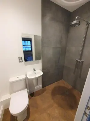 a bathroom with a toilet and a sink and a shower at The Eden Warehouse - Gold Apartment, sleeps 6 in Southport