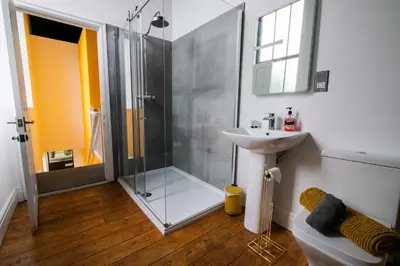a bathroom with a shower and a sink at The Eden Warehouse - Gold Apartment, sleeps 6 in Southport