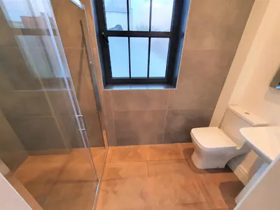 a bathroom with a shower and a toilet at The Eden Warehouse - Green Apartment, sleeps 5 in Southport