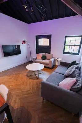 a living room with a couch and a table at The Eden Warehouse - Green Apartment, sleeps 5 in Southport