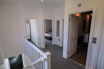 a hallway with a staircase leading to a bedroom at The Eden Warehouse - Green Apartment, sleeps 5 in Southport