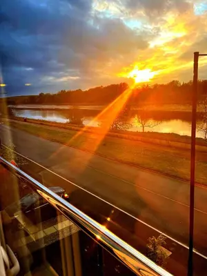 a view of a highway with the sunset in the background at Large En-Suite with Stunning River Views in Lancaster in Torrisholme