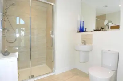 a bathroom with a shower and a toilet and a sink at Large En-Suite with Stunning River Views in Lancaster in Torrisholme