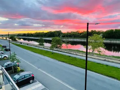 a road with a car parked on the side of a river at Large En-Suite with Stunning River Views in Lancaster in Torrisholme