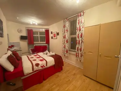 a bedroom with a bed and a dresser and a window at Mellory hotel in Blackpool