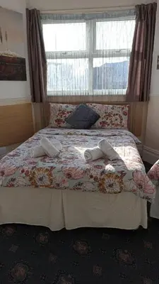 a bedroom with a bed with two towels on it at Mellory hotel in Blackpool