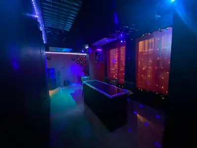 a dark room with purple and blue lights at Mellory hotel in Blackpool