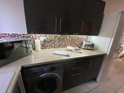 a kitchen with a washing machine on a counter at Spacious City Centre Property in Lancaster