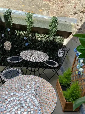 a patio with a table and chairs and plants at Spacious City Centre Property in Lancaster