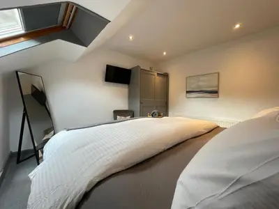a bedroom with a large white bed and a window at Spacious City Centre Property in Lancaster